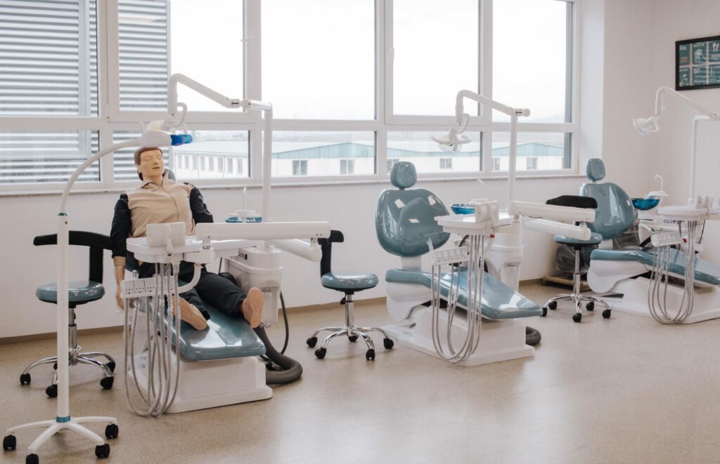 Dental training chairs and equipment configured for clinical education environments