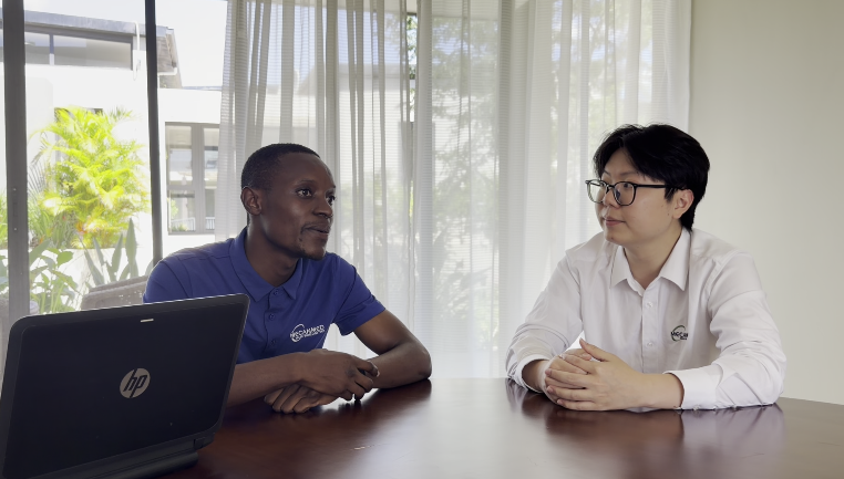 Ray and local engineer Derrick Banda discuss medical equipment support and after-sales service for Zambian hospitals in person.