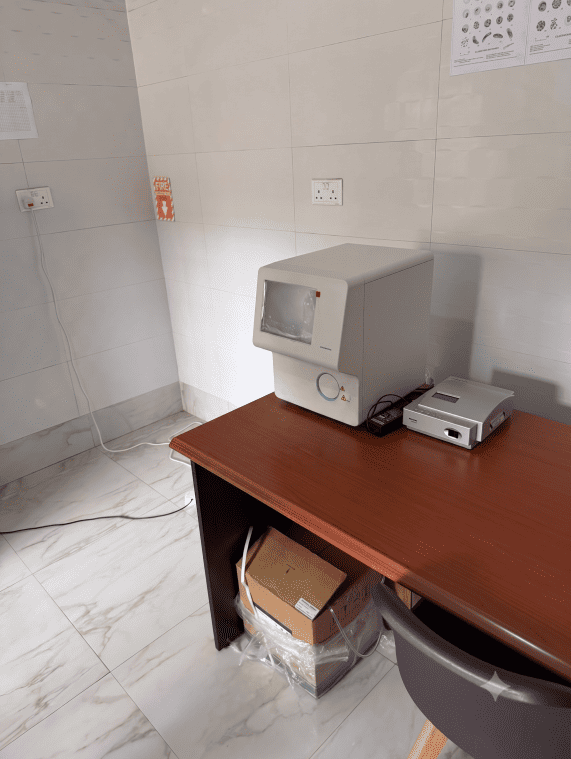 An automated hematology analyzer machine installed inside a hospital laboratory workstation in Zambia for blood testing.