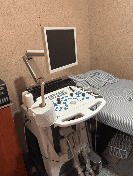 An advanced medical ultrasound diagnostic machine equipped inside a hospital examination room in Zambia for patient imaging.