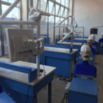 Medical school dental simulation training laboratory equipped with clinical phantom head mannequins and monitors in Zambia.