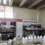 Comprehensive science and technology laboratory room inside a public university equipped with reagent bottles and benches.